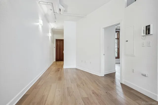 a view of hallway with wooden floor