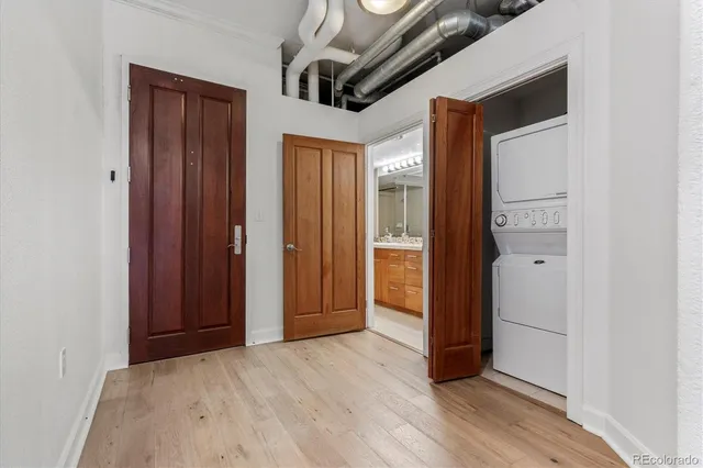 a view of a big room with wooden floor and windows