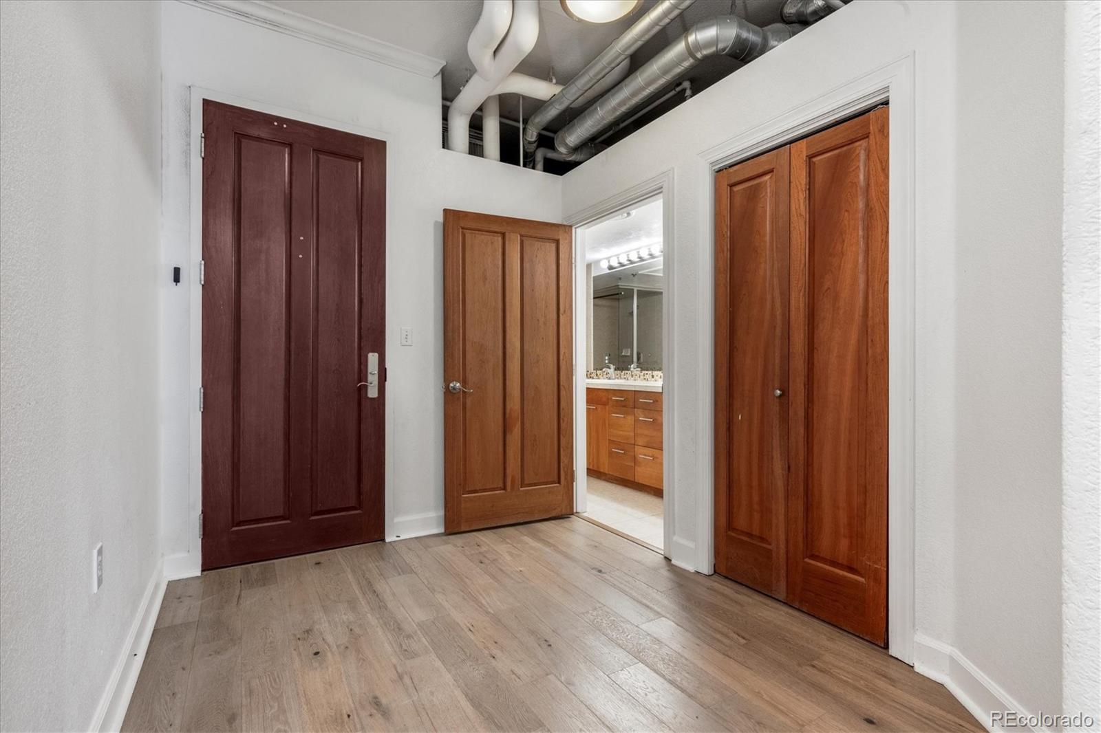 2245 Blake Street, Unit F Denver, CO 80205 - Photo 35 of 38 a view of hallway with wooden floor