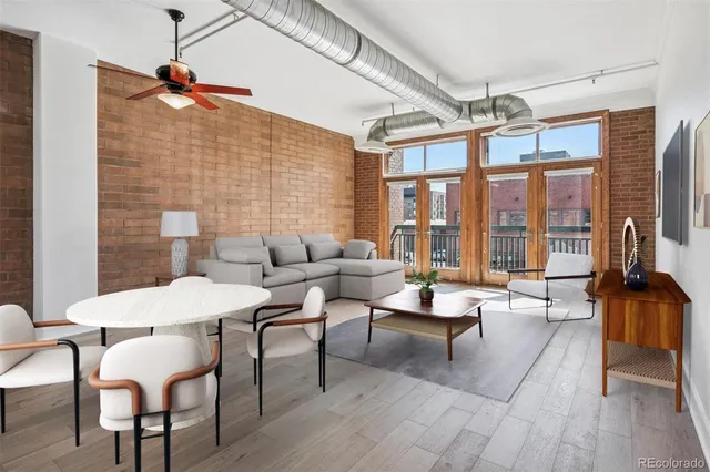 a living room with furniture a flat screen tv and a table
