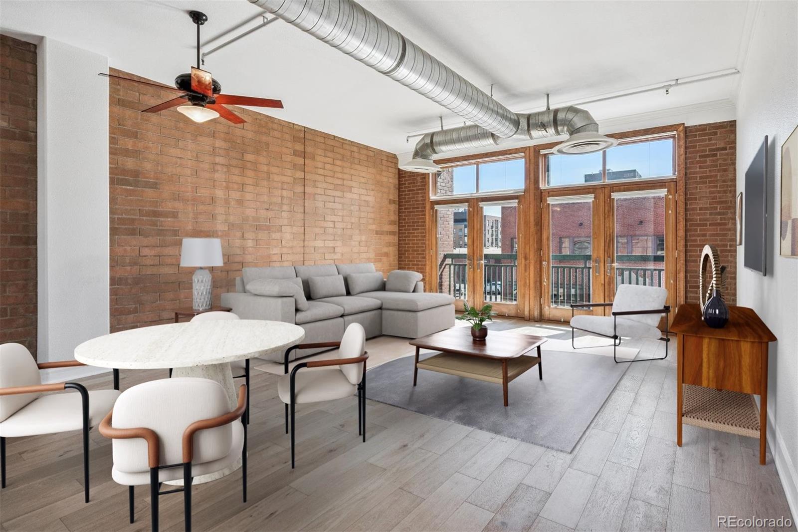 2245 Blake Street, Unit F Denver, CO 80205 - Photo 7 of 38 a living room with furniture a flat screen tv and a table