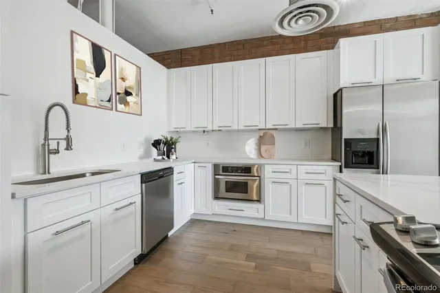 a kitchen with cabinets stainless steel appliances and a counter space