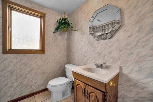 a bathroom with a sink toilet and a mirror