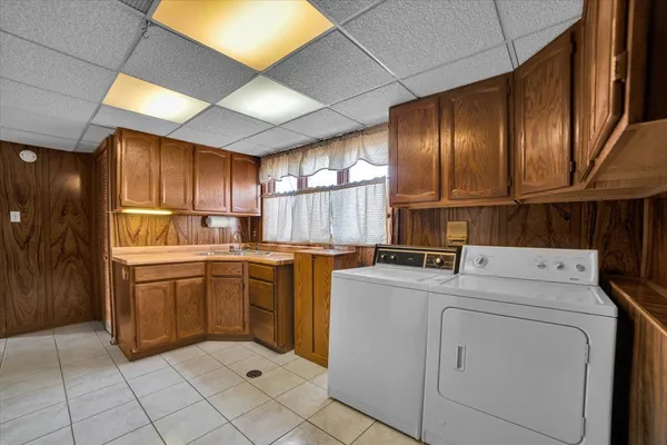 a kitchen with cabinets and washer dryer