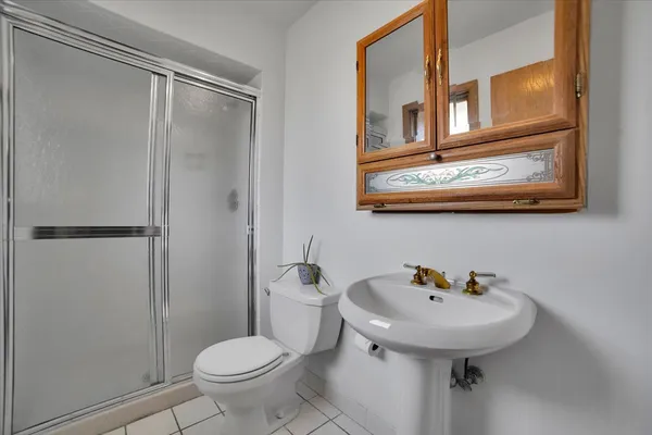 a bathroom with a sink toilet and a mirror