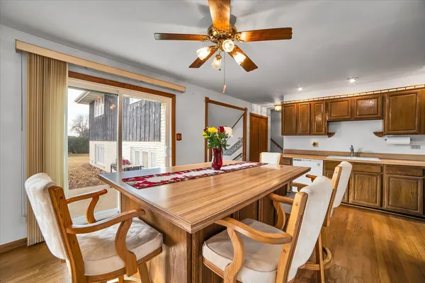 a view of a dining room with furniture a chandelier and wooden floor