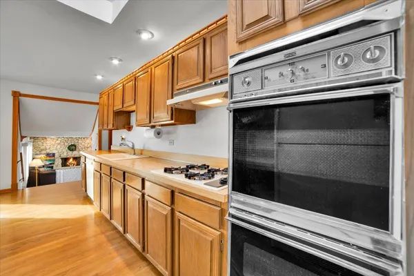 a kitchen with stainless steel appliances granite countertop a stove and a microwave