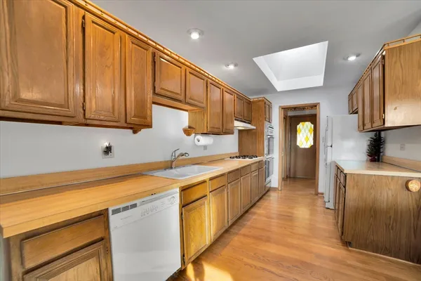 a kitchen with stainless steel appliances granite countertop a sink stove and cabinets