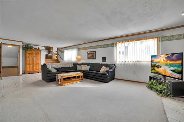a living room with furniture windows and a flat screen tv