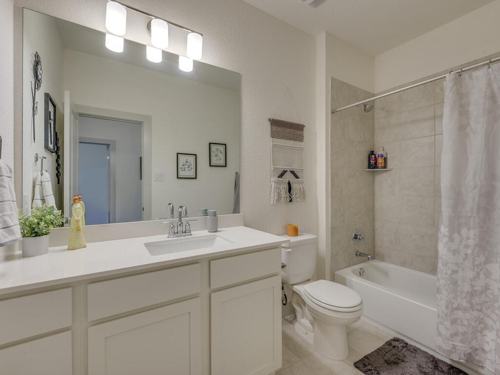 2257 Local Rebel Loop Leander, TX 78641 - Photo 23 of 26 a bathroom with a sink a toilet and shower