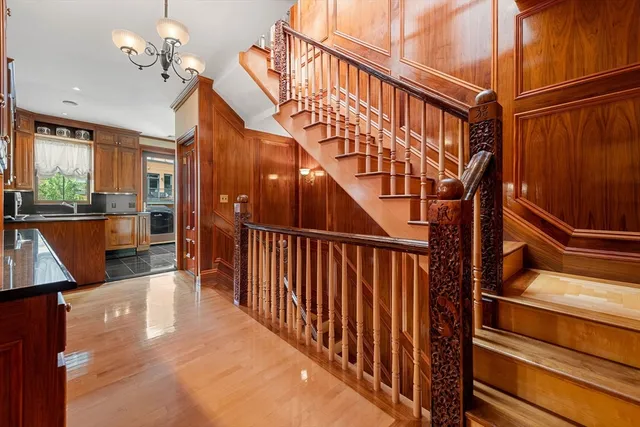 a view of entryway and hall with wooden floor