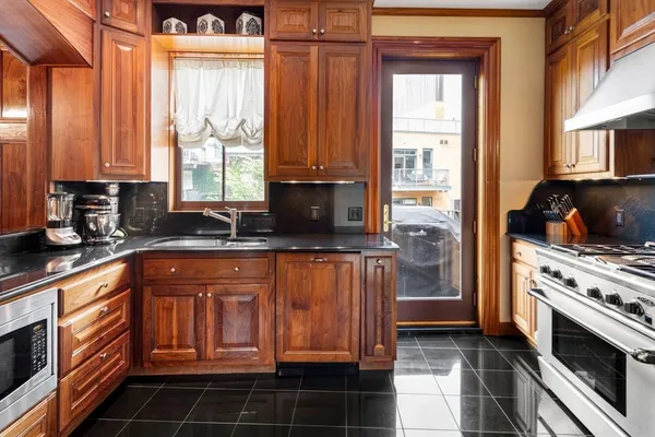 a kitchen with stainless steel appliances a stove a sink and a microwave