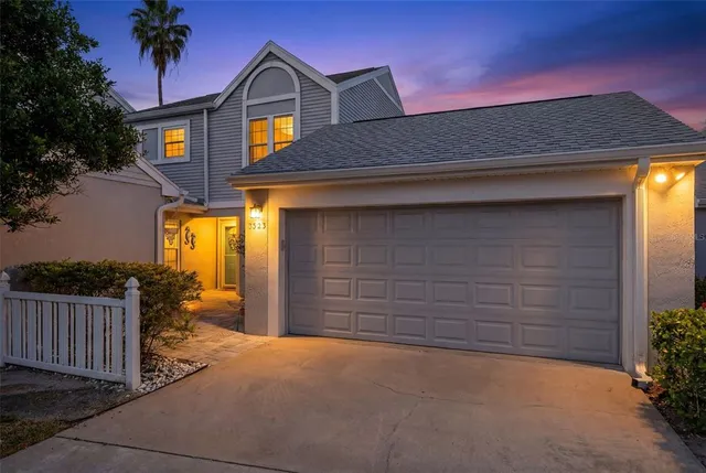 a view of a patio with dining table and chairs under an umbrella