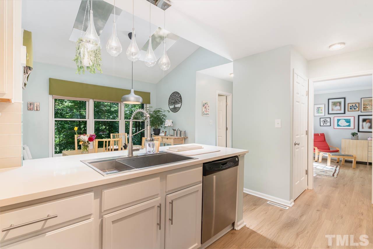 406 Old Fox Trail Durham, NC 27713 - Photo 11 of 23 a dining hall with granite countertop a sink and chandelier
