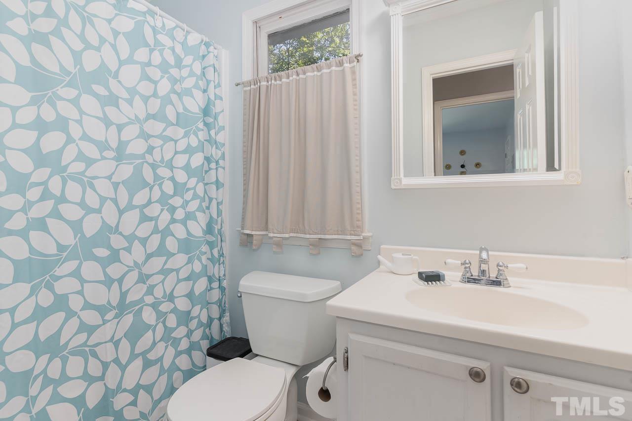406 Old Fox Trail Durham, NC 27713 - Photo 16 of 23 a bathroom with a sink a toilet and a mirror
