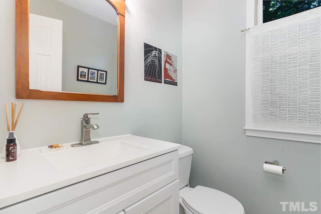 406 Old Fox Trail Durham, NC 27713 - Photo 19 of 23 a bathroom with a toilet sink and mirror