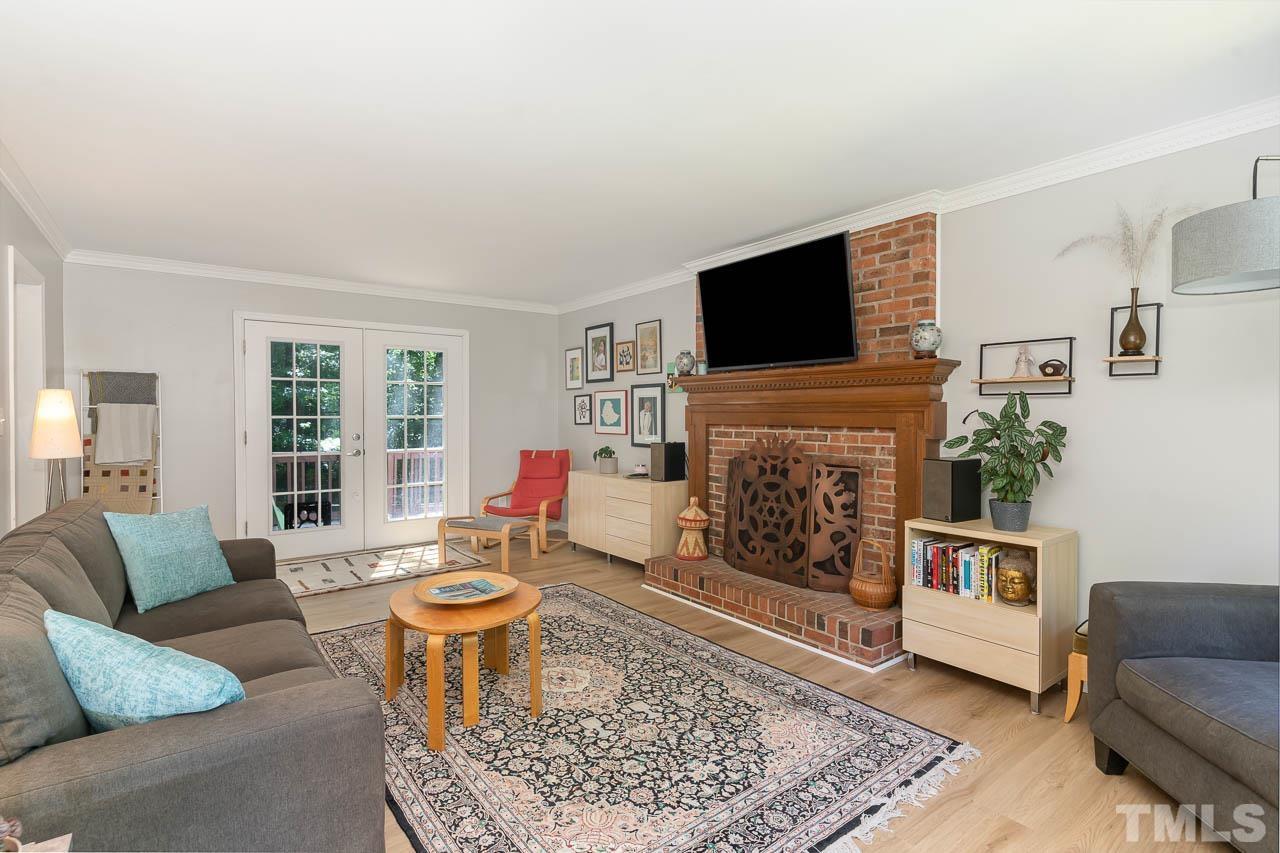 406 Old Fox Trail Durham, NC 27713 - Photo 6 of 23 a living room with furniture a flat screen tv and a fireplace