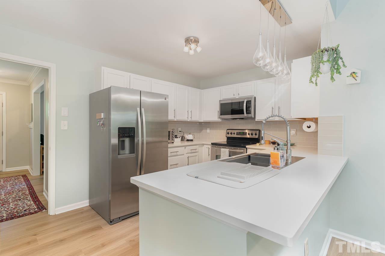 406 Old Fox Trail Durham, NC 27713 - Photo 10 of 23 a kitchen with a refrigerator a stove and a sink