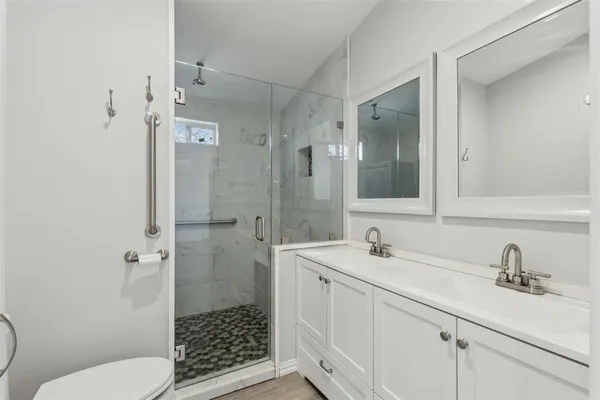a bathroom with a sink toilet and shower