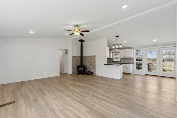 a view of a kitchen with furniture and wooden floor