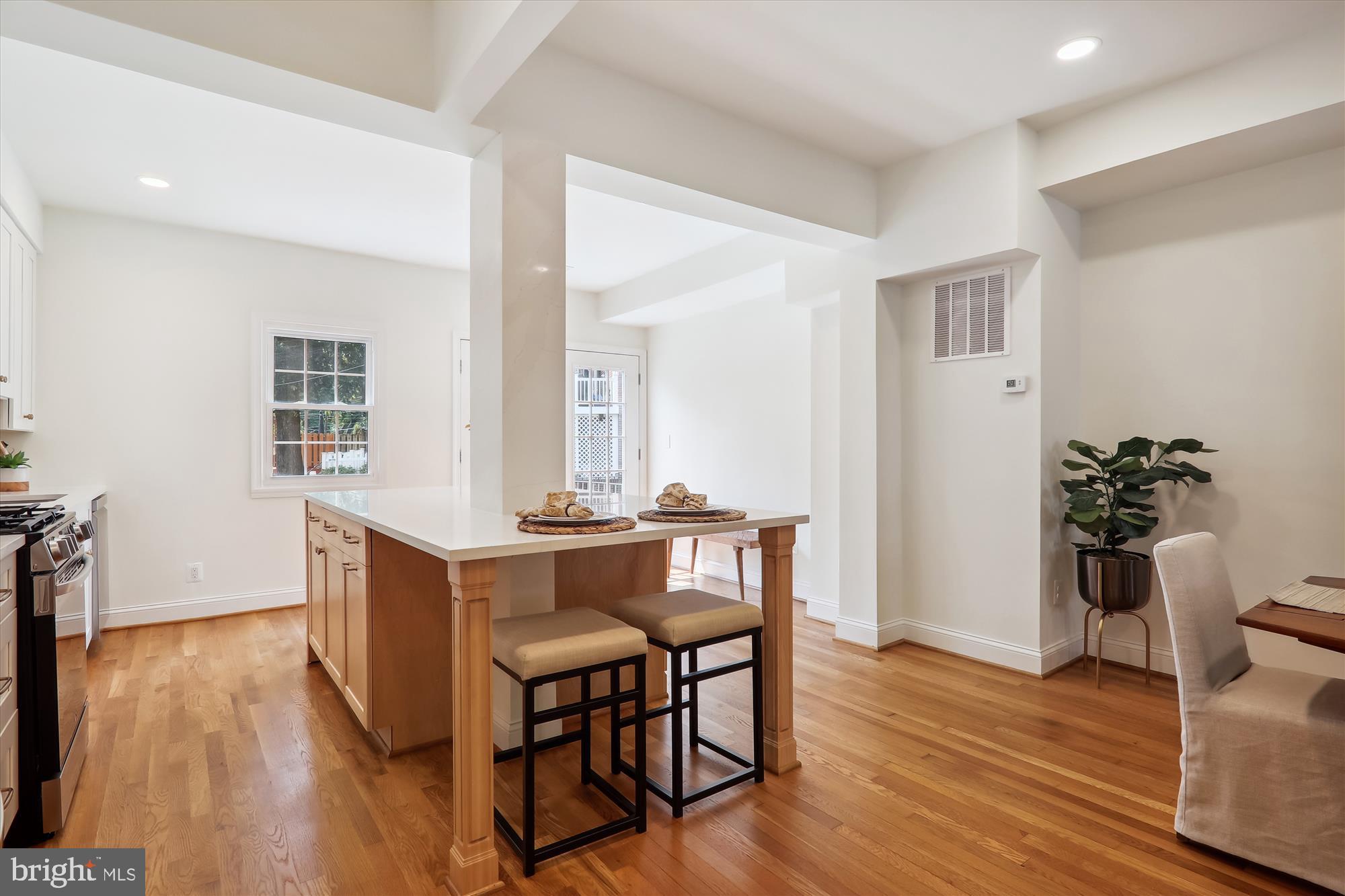2462 Tunlaw Road Northwest Washington, DC 20007 - Photo 14 of 56 a view of a dining room with furniture and wooden floor