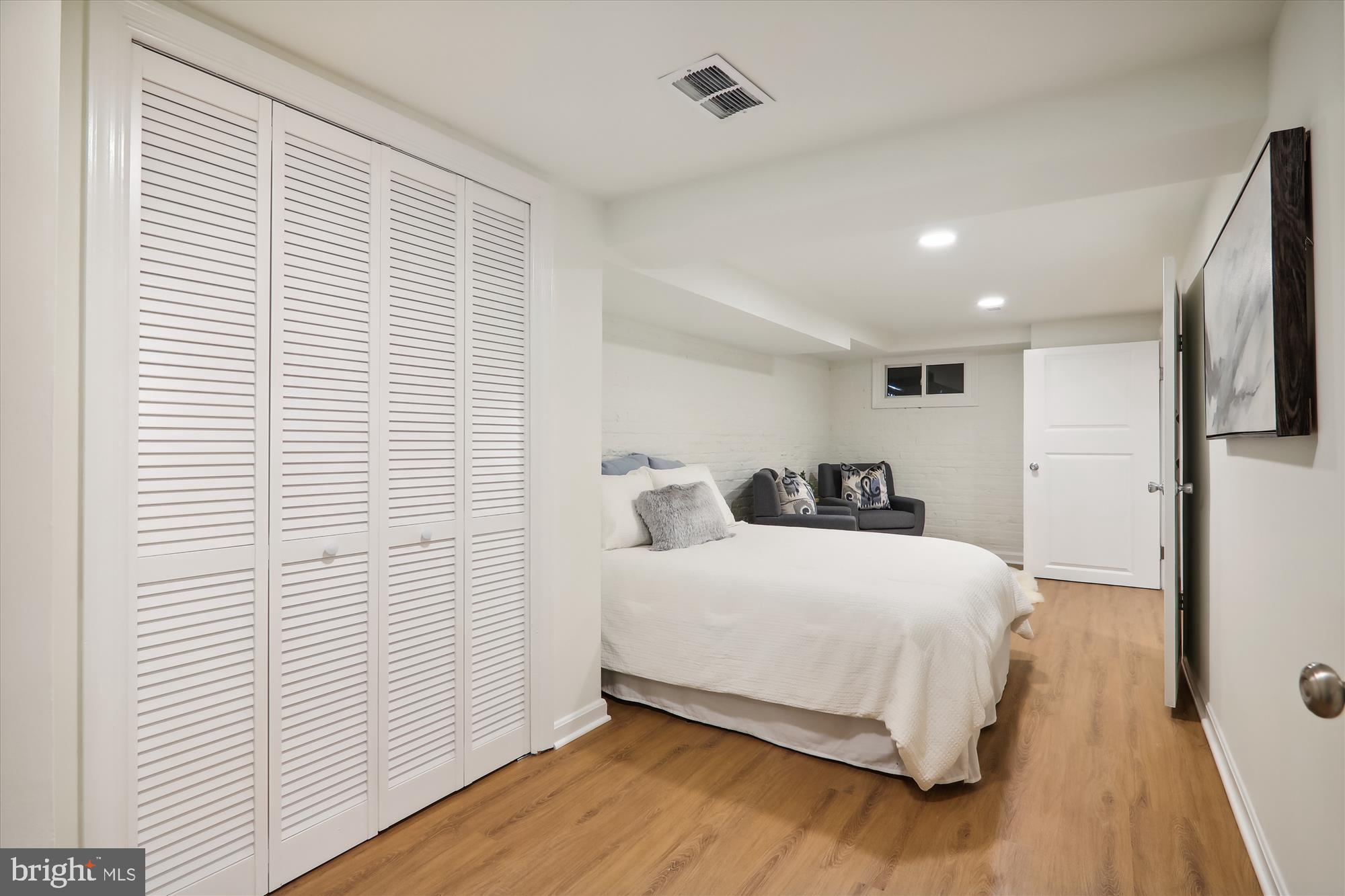 2462 Tunlaw Road Northwest Washington, DC 20007 - Photo 35 of 56 a bedroom with a bed and a flat screen tv