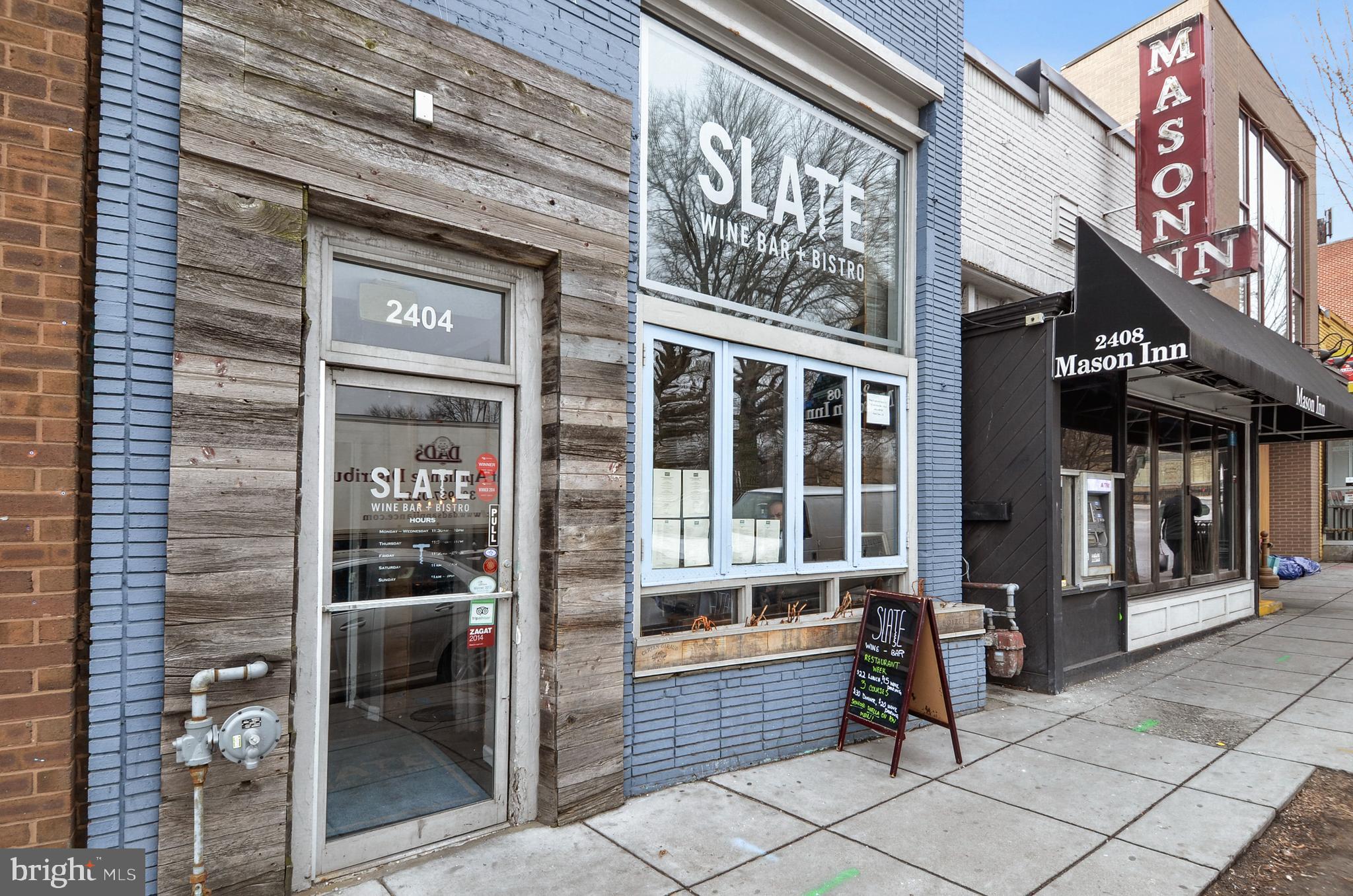 2462 Tunlaw Road Northwest Washington, DC 20007 - Photo 47 of 56 a view of a brick building with a bench in front of building
