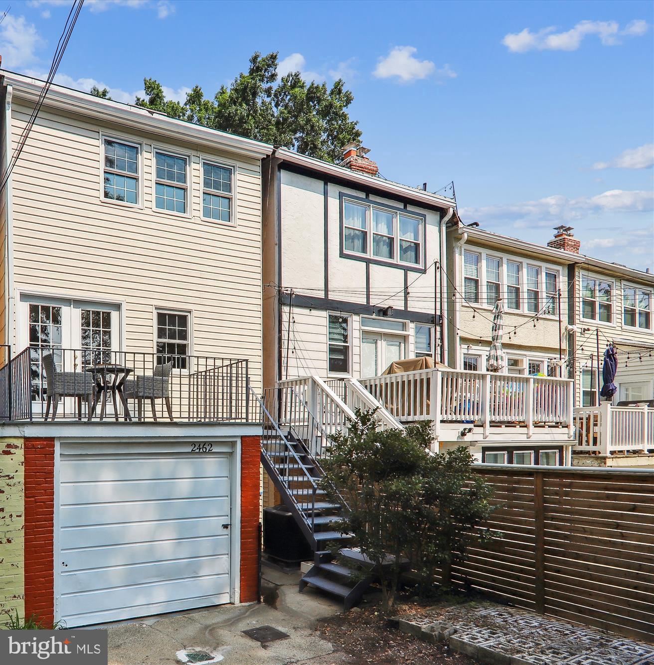 2462 Tunlaw Road Northwest Washington, DC 20007 - Photo 5 of 56 a front view of a house with a yard
