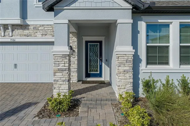 a front view of a house with a plants