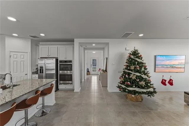 a kitchen with kitchen island granite countertop lots of counter top space and stainless steel appliances