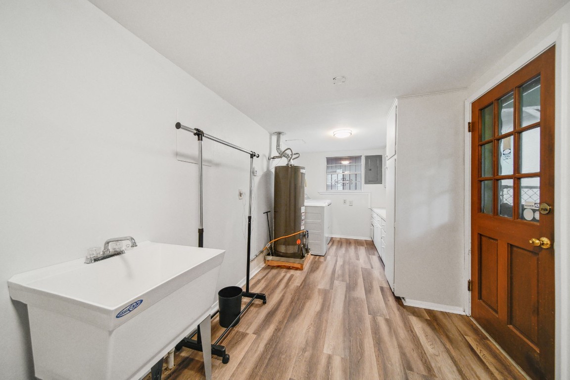 2019 North Thompson Street, Unit A Conroe, TX 77301 - Photo 12 of 17 Large utility room with full size washer and dryer, cabinets, and sink.