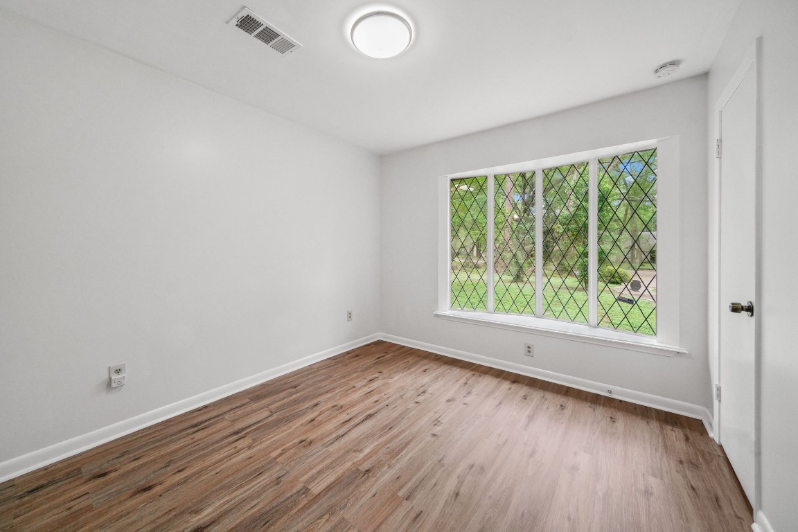 2019 North Thompson Street, Unit A Conroe, TX 77301 - Photo 6 of 17 Front bedroom with natural light and plank flooring