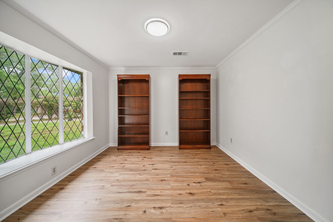 2019 North Thompson Street, Unit A Conroe, TX 77301 - Photo 7 of 17 Bedroom with bookcases looks out to front yard.