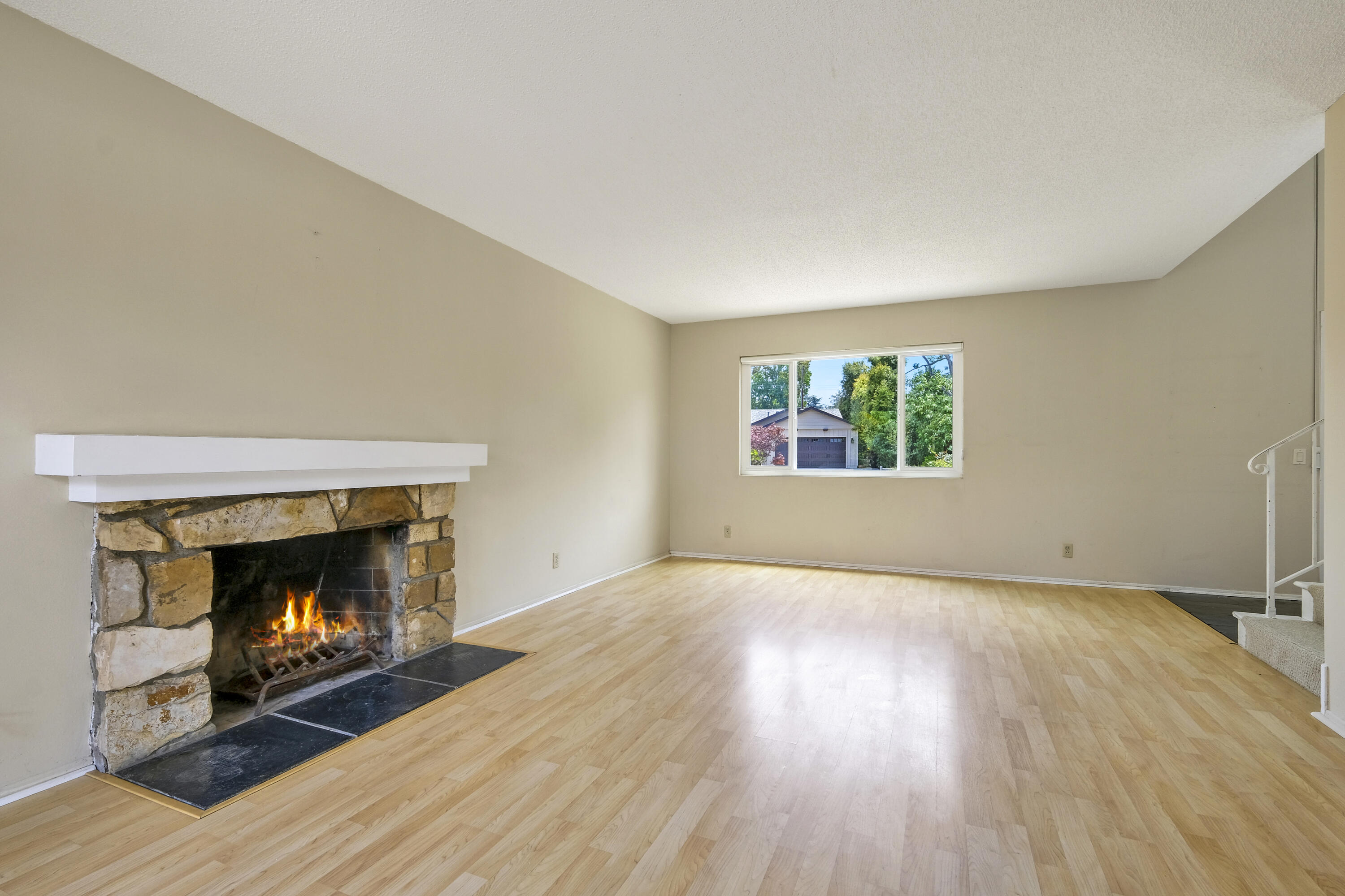 5376 Berkeley Road Santa Barbara, CA 93111 - Photo 4 of 18 a view of an empty room with wooden floor fireplace and a window