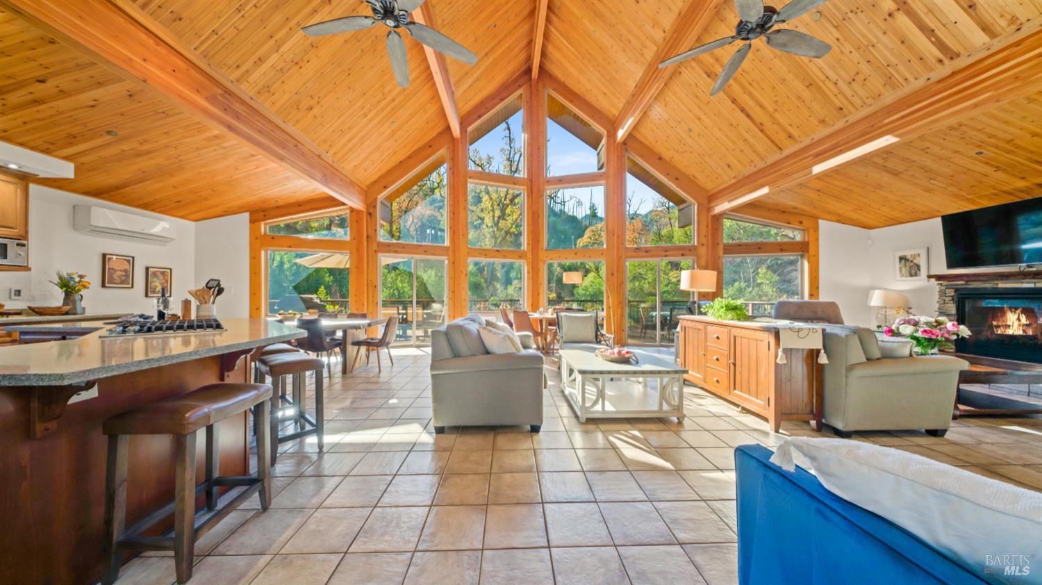 11081 Van Dorn Reservoir Road, Unit 1 Middletown, CA 95461 - Photo 17 of 68 a living room with furniture a flat screen tv and large windows