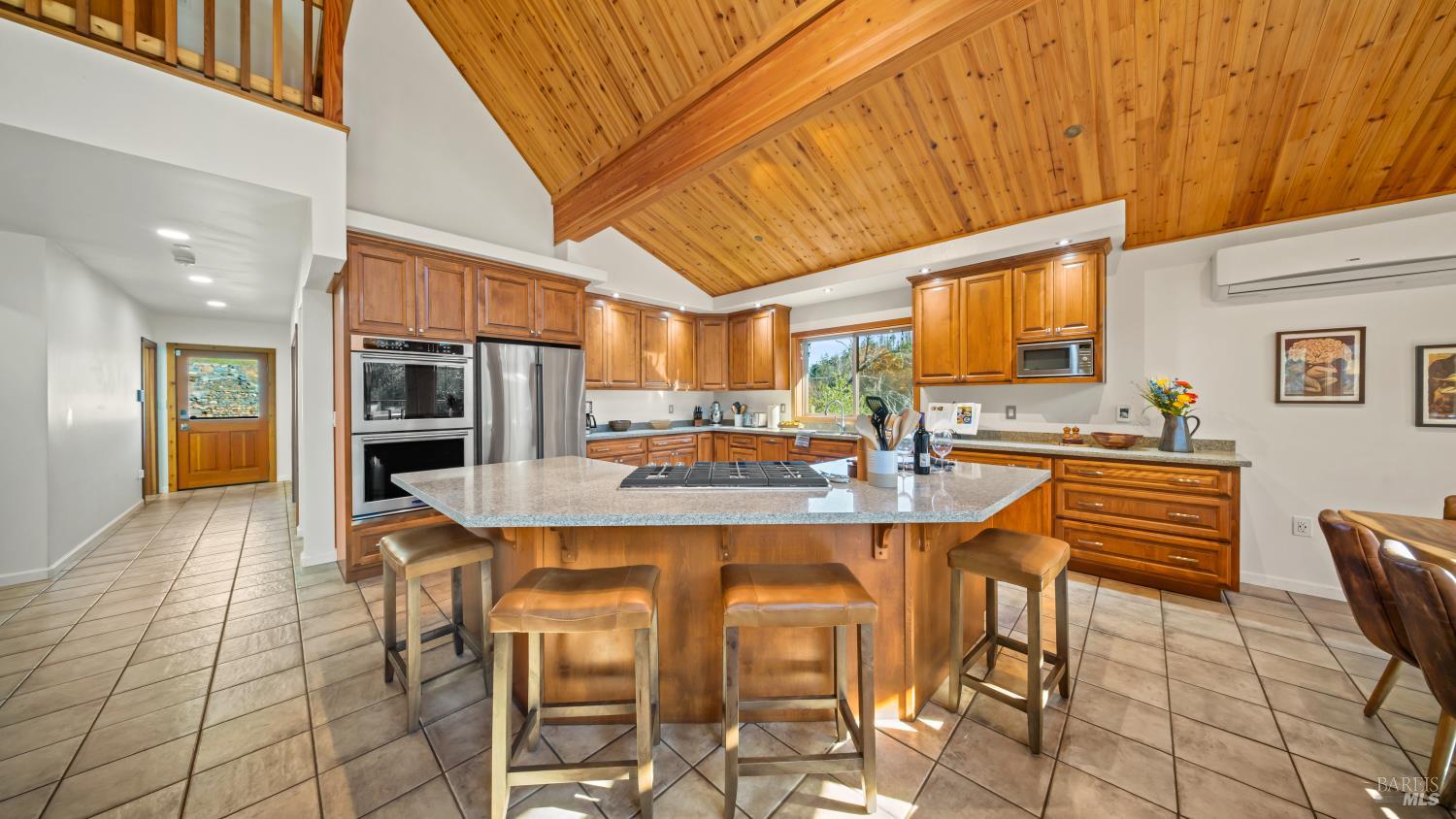 11081 Van Dorn Reservoir Road, Unit 1 Middletown, CA 95461 - Photo 21 of 68 a dining hall with stainless steel appliances kitchen island granite countertop a dining table and chairs