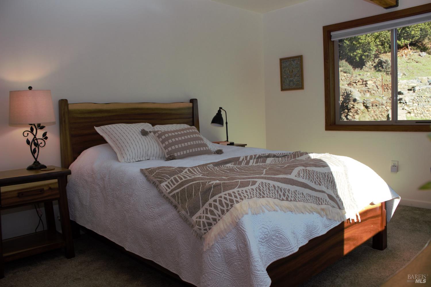 11081 Van Dorn Reservoir Road, Unit 1 Middletown, CA 95461 - Photo 49 of 68 a bedroom with a bed and a window