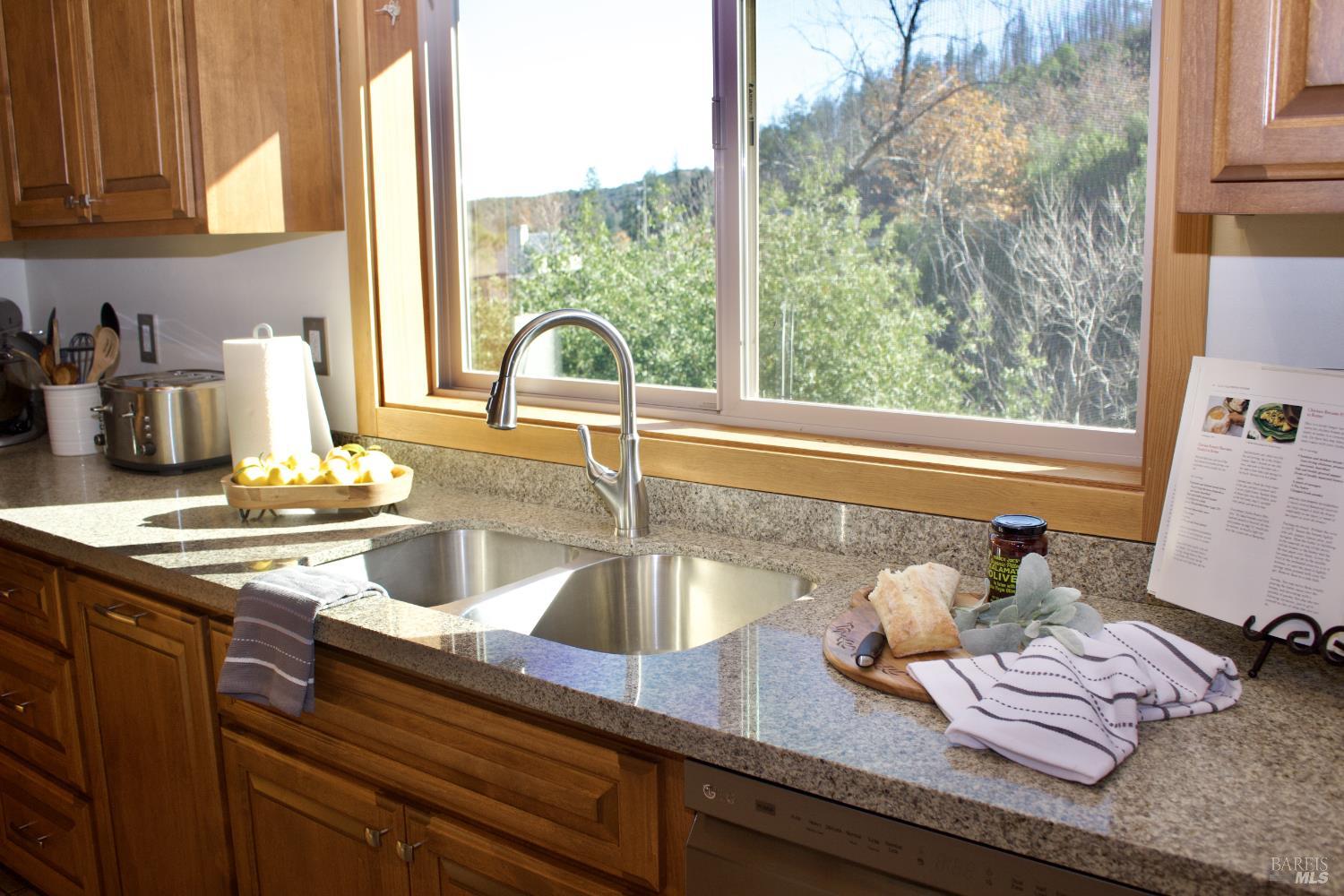 11081 Van Dorn Reservoir Road, Unit 1 Middletown, CA 95461 - Photo 59 of 68 a kitchen with granite countertop sink and cabinets