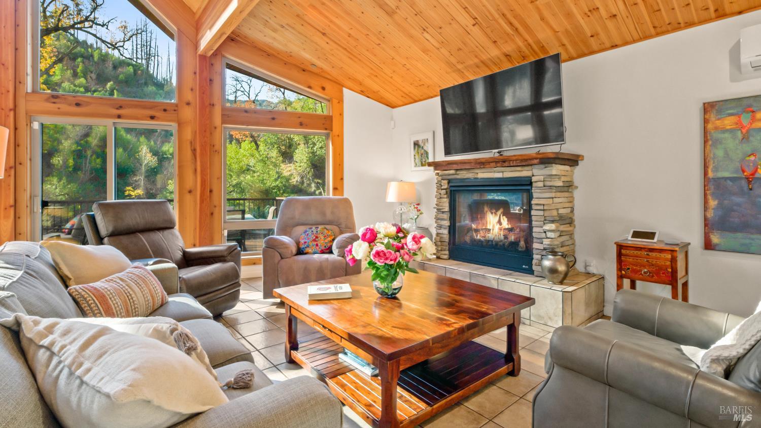 11081 Van Dorn Reservoir Road, Unit 1 Middletown, CA 95461 - Photo 6 of 68 a living room with furniture a fireplace and a large window