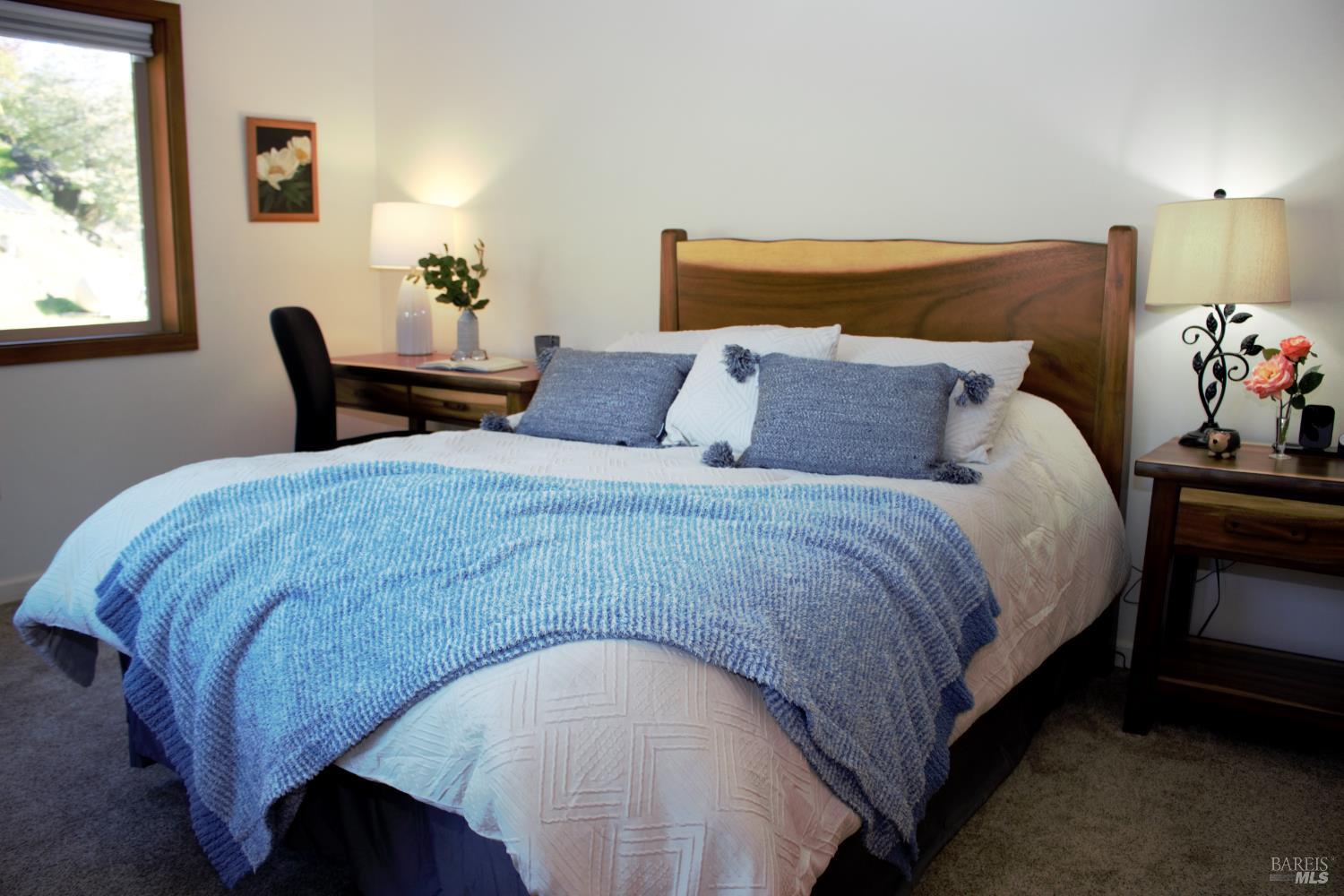 11081 Van Dorn Reservoir Road, Unit 1 Middletown, CA 95461 - Photo 63 of 68 a bed sitting in a bedroom next to a window