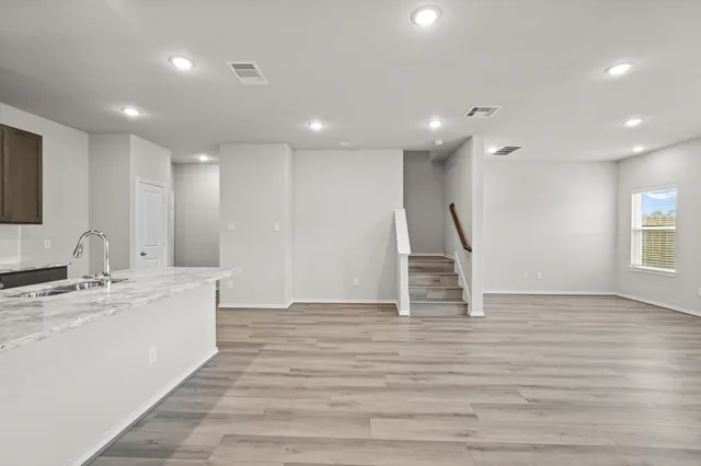 a view of kitchen with wooden floor and electronic appliances