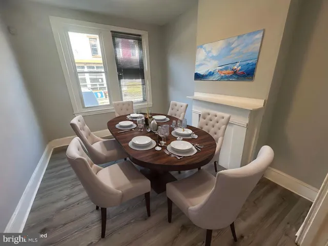 a view of a dining room with furniture and wooden floor
