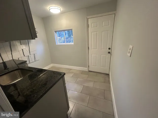 a living room with a couch and a lamp