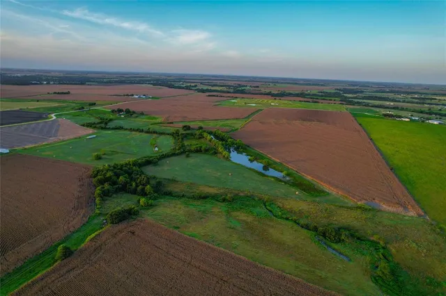 an aerial view of a golf course with a lake view