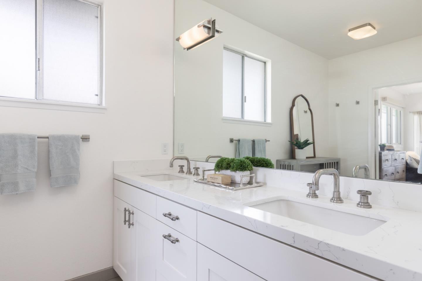2715 Ribera Road Carmel, CA 93923 - Photo 21 of 41 a bathroom with double sink and a mirror