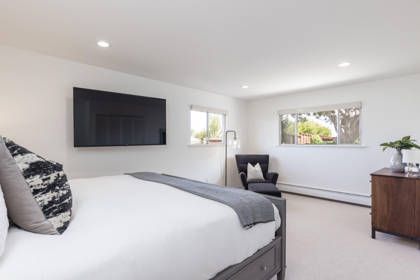 2715 Ribera Road Carmel, CA 93923 - Photo 22 of 41 a bedroom with a bed and a flat screen tv