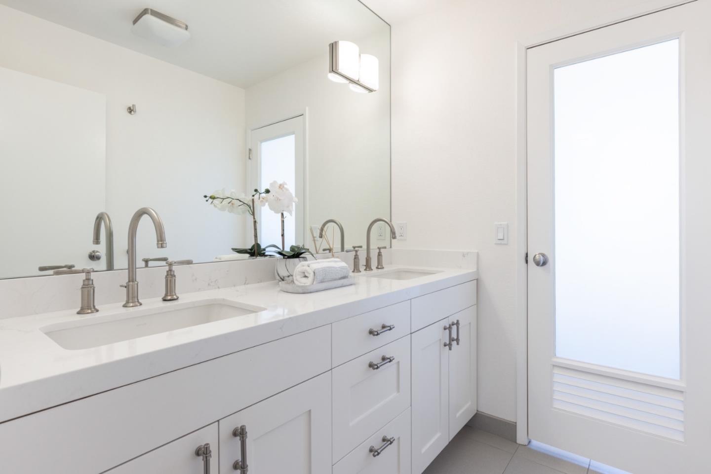 2715 Ribera Road Carmel, CA 93923 - Photo 23 of 41 a bathroom with double sink and a mirror