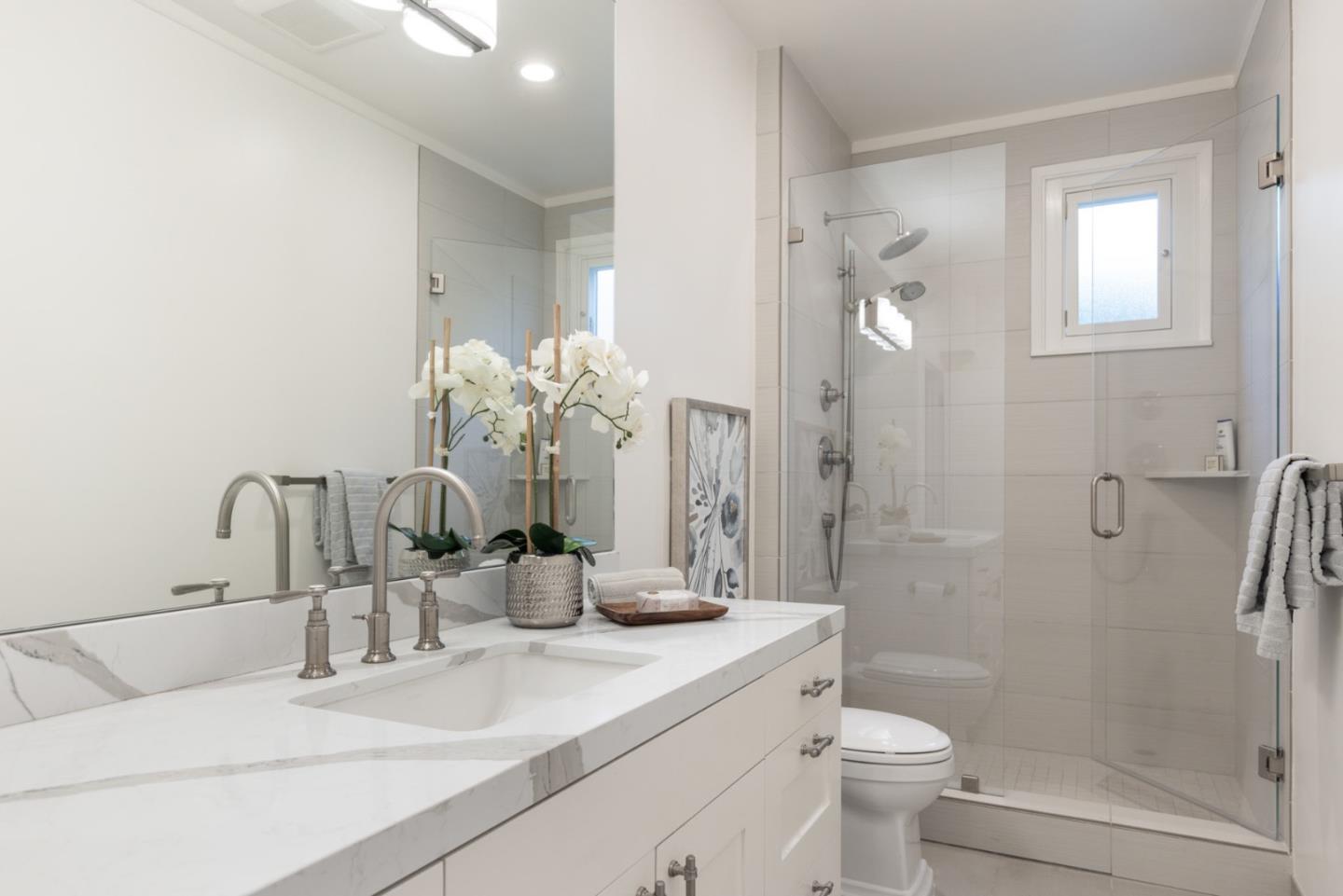 2715 Ribera Road Carmel, CA 93923 - Photo 27 of 41 a bathroom with a double vanity sink toilet and shower