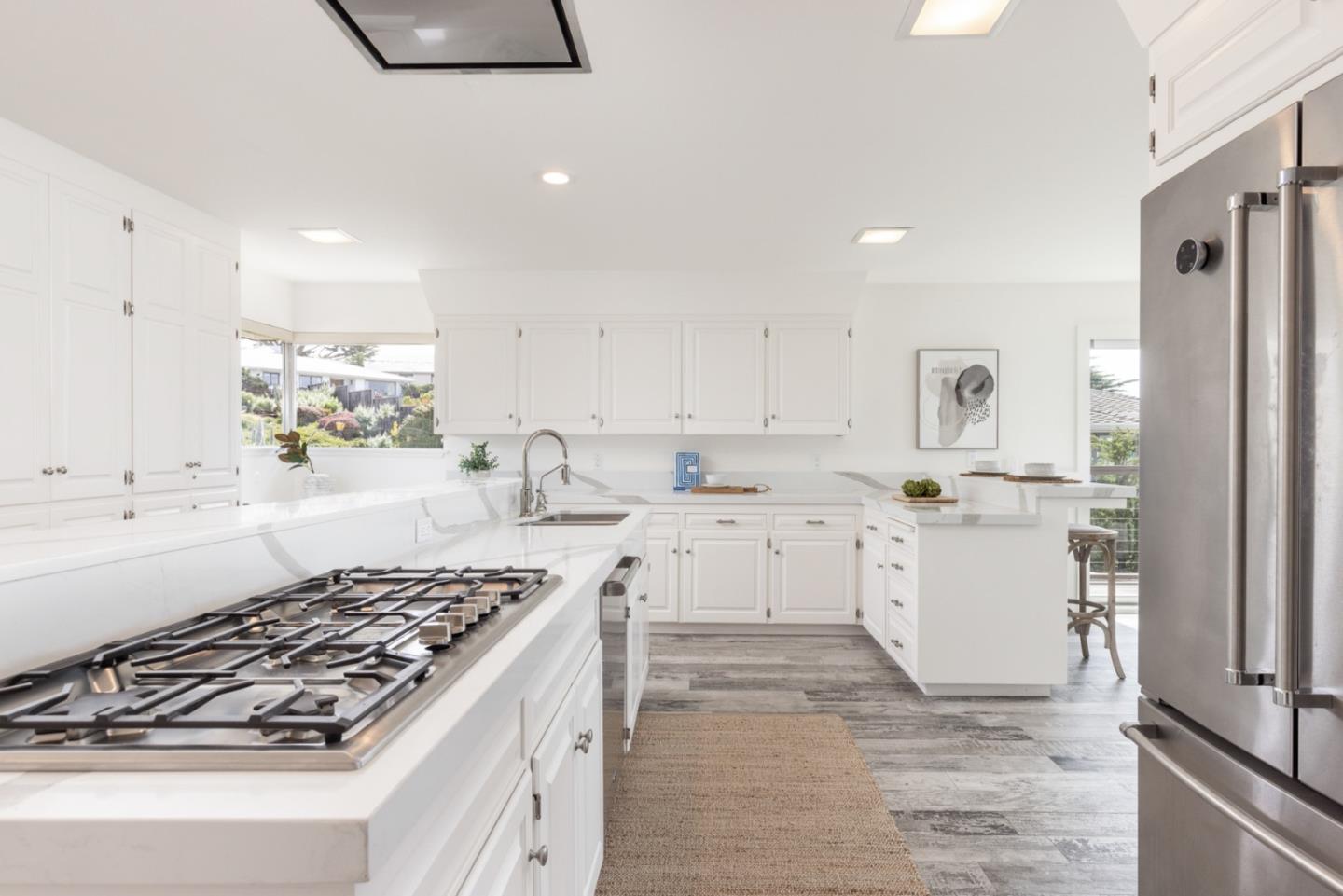 2715 Ribera Road Carmel, CA 93923 - Photo 10 of 41 a kitchen with white cabinets and appliances