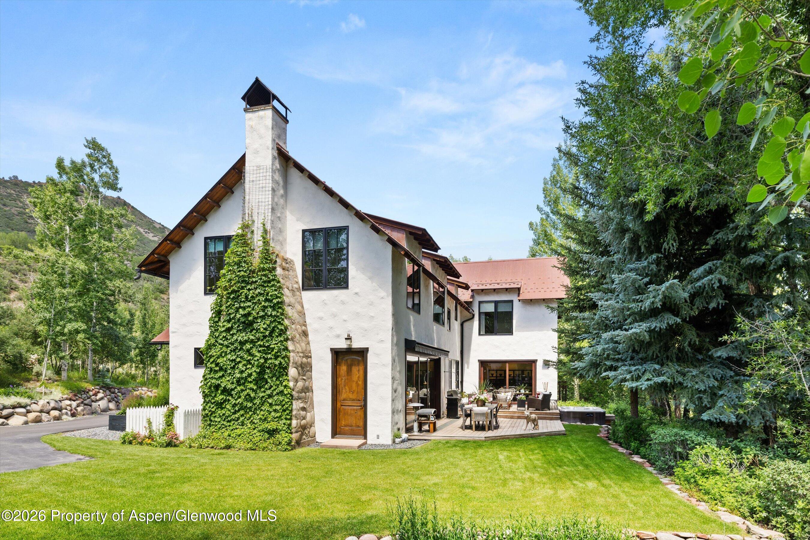 256 Twining Flats Road Aspen, CO 81611 - Photo 2 of 42 a front view of a house with garden